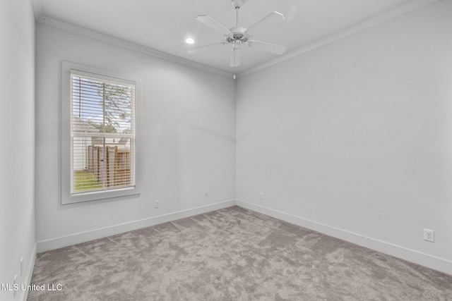 unfurnished room featuring carpet flooring, baseboards, crown molding, and a ceiling fan