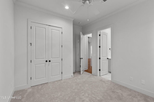 unfurnished bedroom with a closet, baseboards, carpet, crown molding, and recessed lighting
