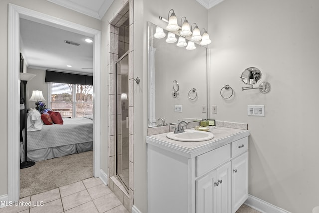 ensuite bathroom with vanity, tile patterned floors, visible vents, and ornamental molding