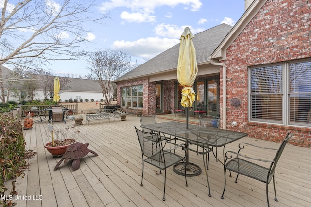 wooden deck featuring outdoor dining area