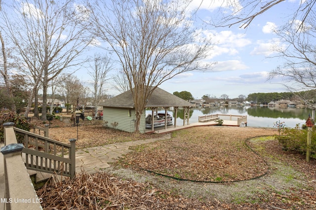 view of yard with a boat dock and a water view