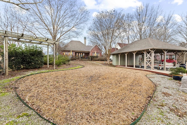 view of yard featuring a pergola and a deck