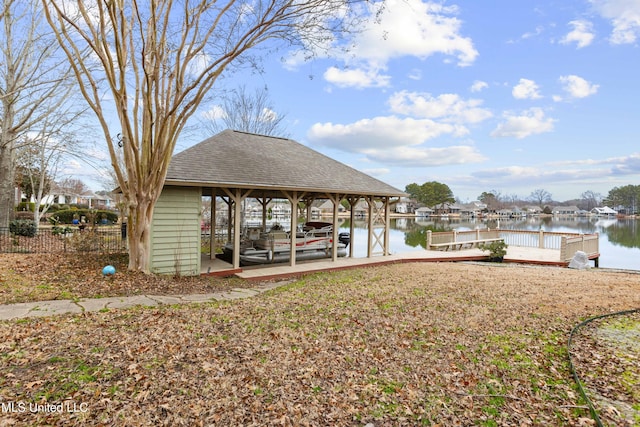 dock area featuring a water view and fence