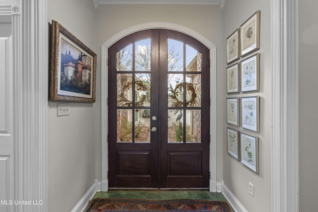 doorway featuring french doors and baseboards