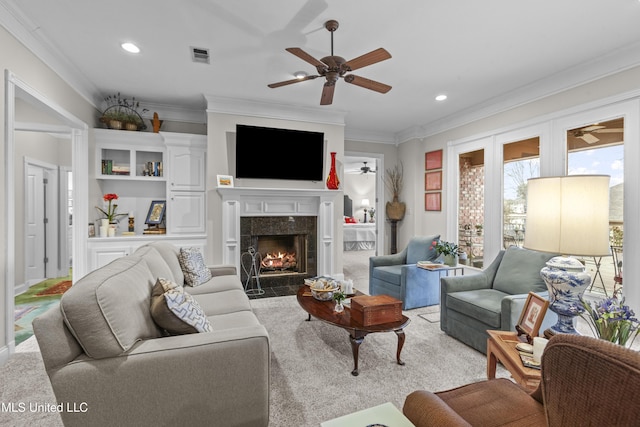 living room with visible vents, crown molding, recessed lighting, a tile fireplace, and a ceiling fan