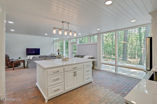 1844 Eastover Dr, Jackson, MS 39211 - kitchen with recessed lighting, brick floor, white cabinets, and decorative light fixtures
