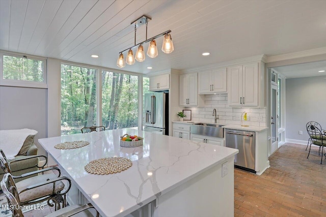 1844 Eastover Dr, Jackson, MS 39211 - kitchen featuring stainless steel appliances, plenty of natural light, a sink, and brick floor