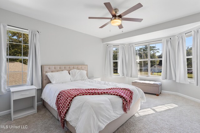 2869 Honduras Dr, Gautier, MS 39553 - carpeted bedroom featuring multiple windows and a ceiling fan