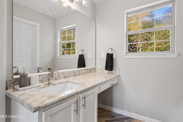 bathroom featuring plenty of natural light, wood-type flooring, and vanity