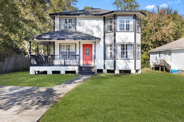 view of front of home with covered porch and a front yard