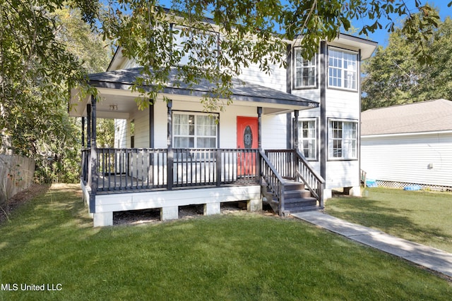 view of front of house with covered porch and a front yard