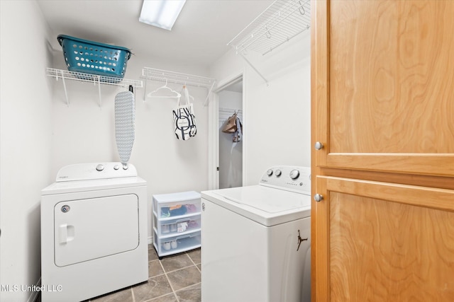 washroom featuring washer and dryer, laundry area, and tile patterned floors