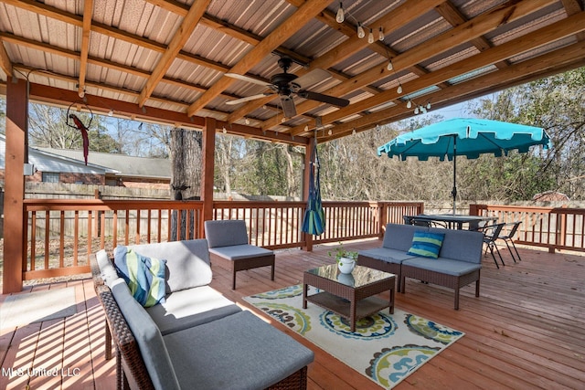 wooden terrace featuring outdoor lounge area, outdoor dining area, and a ceiling fan