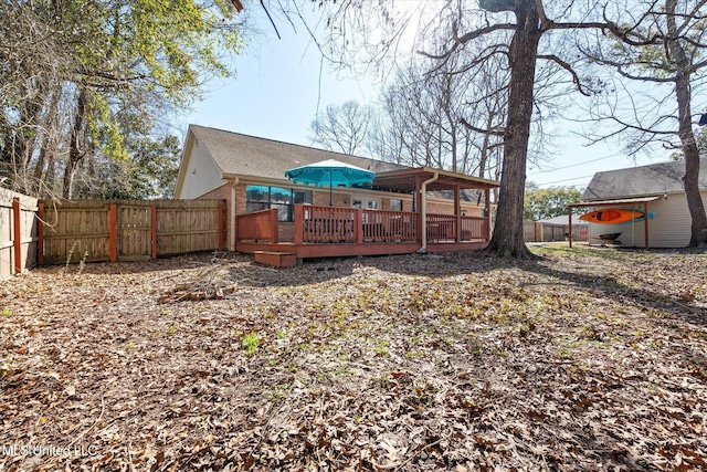 back of house featuring a wooden deck and a fenced backyard