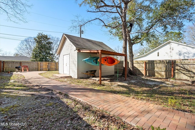 view of yard with an outbuilding, a storage shed, and a fenced backyard