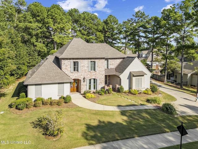 101 Lake Village Dr, Madison, MS 39110 - view of front facade featuring a shingled roof, a front yard, and stucco siding
