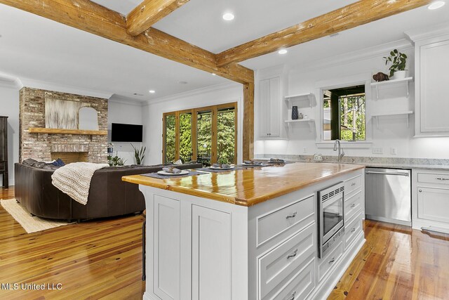 101 Lake Village Dr, Madison, MS 39110 - kitchen featuring light wood-style floors, open shelves, appliances with stainless steel finishes, and plenty of natural light