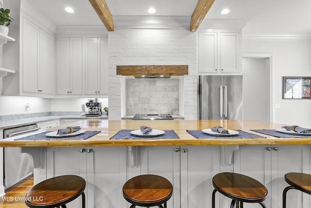 101 Lake Village Dr, Madison, MS 39110 - kitchen with beamed ceiling, open shelves, stainless steel appliances, and white cabinetry