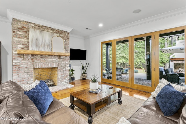 101 Lake Village Dr, Madison, MS 39110 - living room with visible vents, light wood-type flooring, ornamental molding, and a fireplace