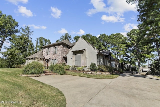 101 Lake Village Dr, Madison, MS 39110 - french country style house featuring a front lawn and brick siding