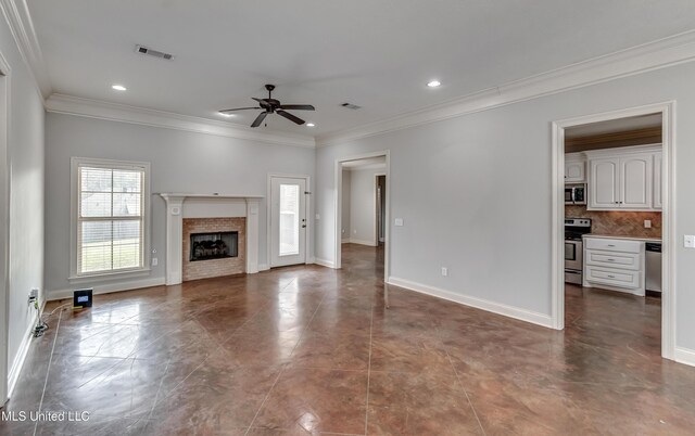 unfurnished living room with visible vents, crown molding, baseboards, a fireplace, and a ceiling fan