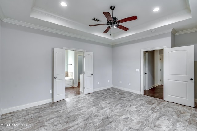 unfurnished bedroom with visible vents, crown molding, and a raised ceiling