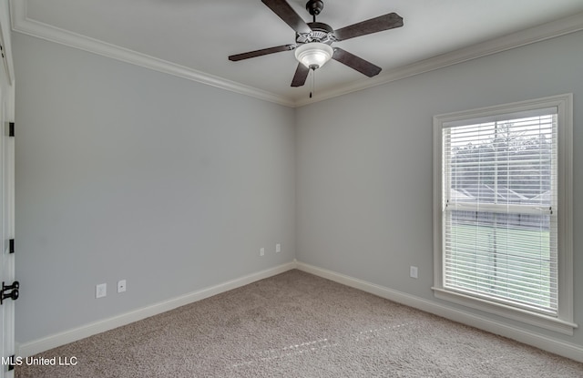 carpeted spare room featuring baseboards, ceiling fan, and crown molding