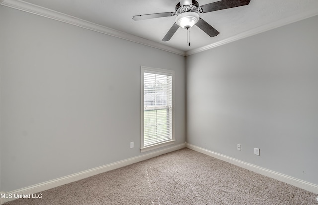 carpeted spare room featuring baseboards, crown molding, and ceiling fan