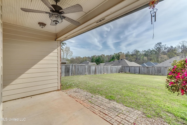 view of yard featuring a fenced backyard, ceiling fan, and a patio area