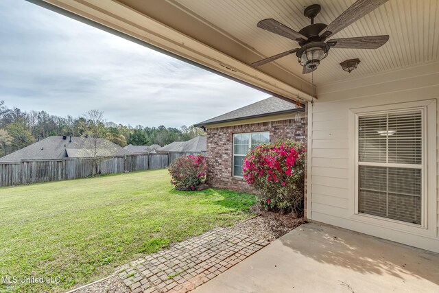 view of yard with a fenced backyard, a patio, and ceiling fan