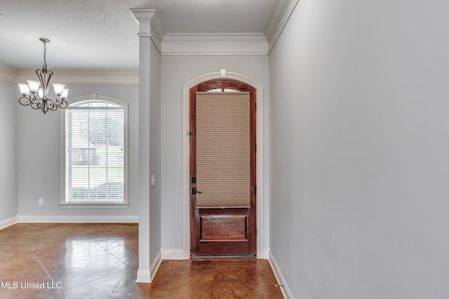 foyer entrance with baseboards, ornamental molding, an inviting chandelier, and dark tile patterned floors
