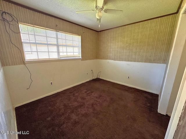 208 Cedar Dr, Diberville, MS 39540 - spare room with a textured ceiling, crown molding, ceiling fan, and dark colored carpet