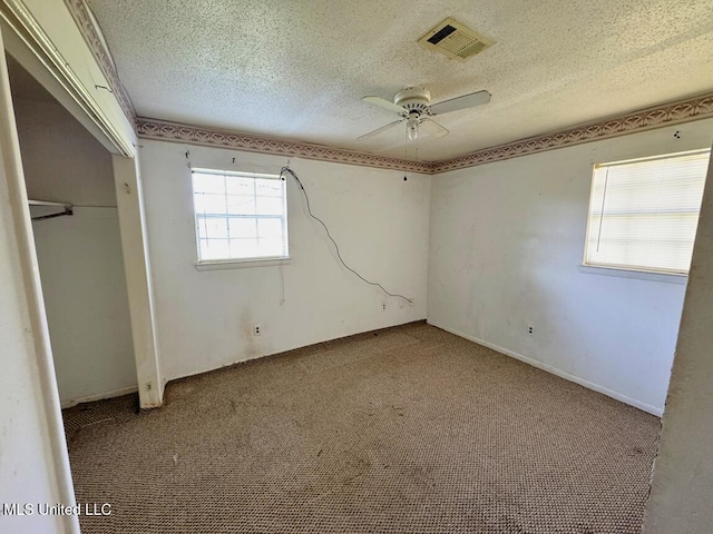 208 Cedar Dr, Diberville, MS 39540 - unfurnished bedroom with a textured ceiling, carpet floors, a closet, and ceiling fan
