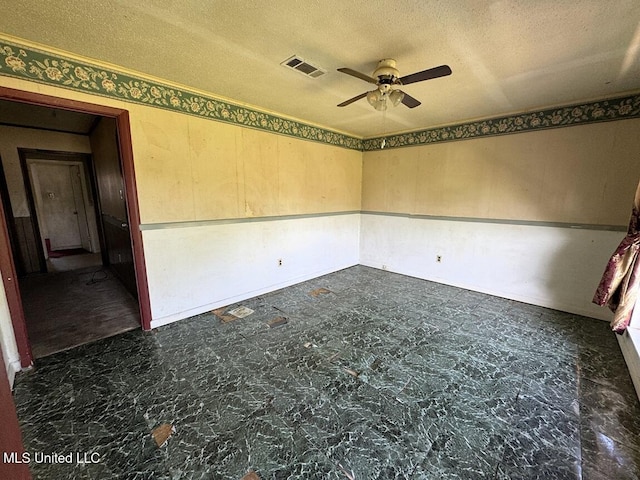 208 Cedar Dr, Diberville, MS 39540 - empty room with ceiling fan and a textured ceiling