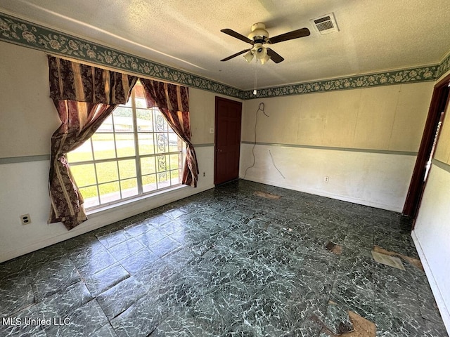208 Cedar Dr, Diberville, MS 39540 - spare room with a ceiling fan and a textured ceiling
