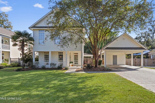 view of front of property featuring covered porch, a carport, and a front lawn