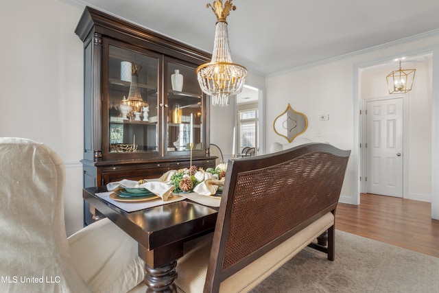 dining area featuring crown molding and hardwood / wood-style flooring