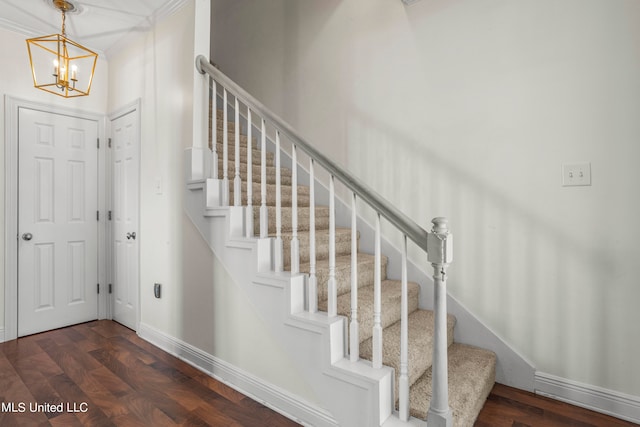 foyer with dark hardwood / wood-style flooring and a chandelier