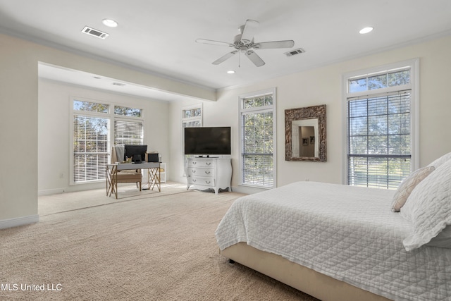 carpeted bedroom with crown molding, multiple windows, and ceiling fan