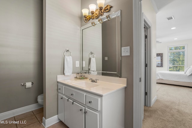 bathroom with vanity, toilet, and tile patterned flooring