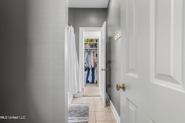 hall featuring light tile patterned flooring