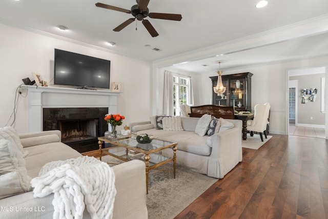 living room featuring ornamental molding, hardwood / wood-style floors, and ceiling fan