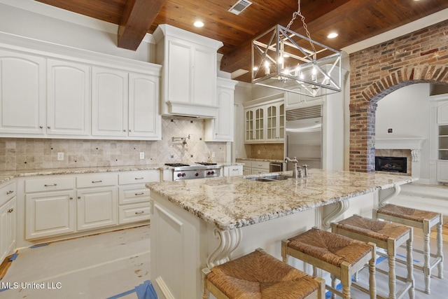 kitchen with wood ceiling, stainless steel appliances, and a sink