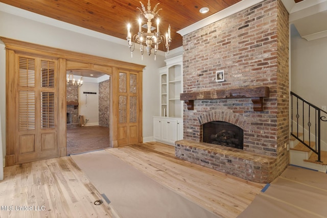 unfurnished living room featuring wood finished floors, a chandelier, a brick fireplace, wood ceiling, and baseboards