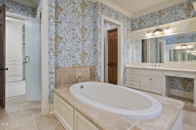 bathroom with wallpapered walls, baseboards, vanity, and a garden tub