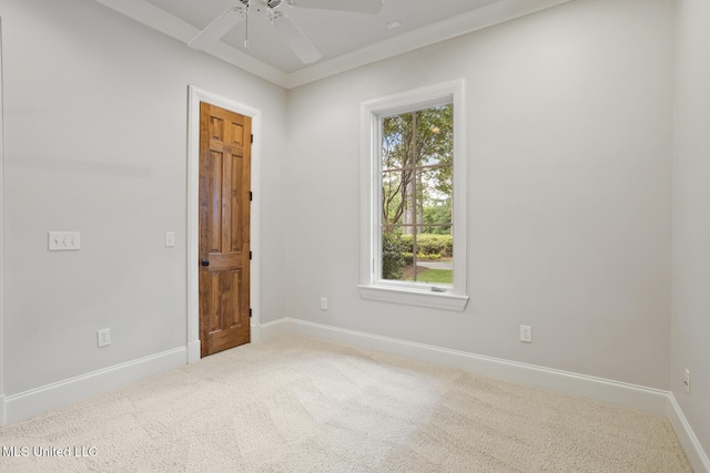 empty room with baseboards, ceiling fan, and carpet floors