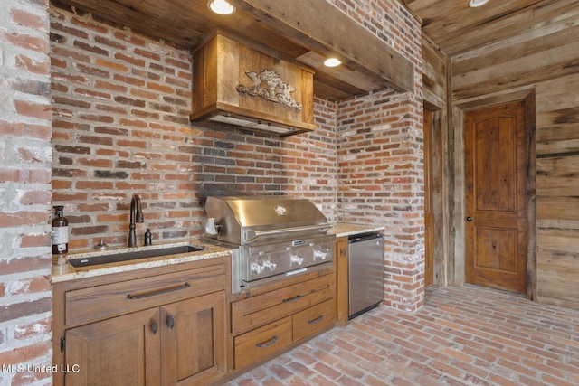 kitchen featuring a sink, fridge, brick floor, wooden ceiling, and light stone countertops