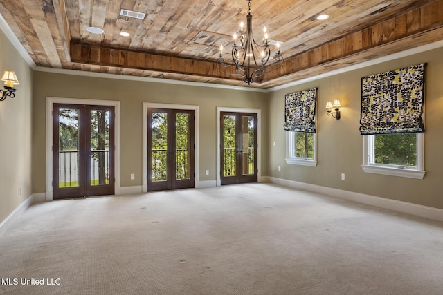 empty room featuring baseboards, an inviting chandelier, french doors, and wooden ceiling