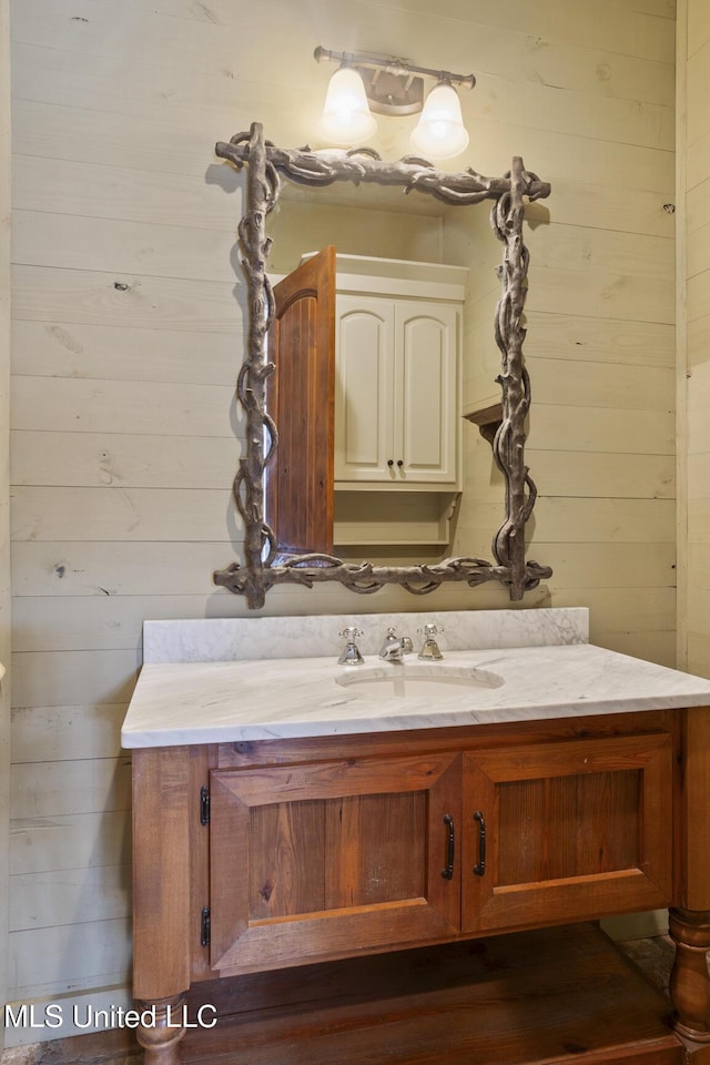 bathroom with wooden walls and vanity