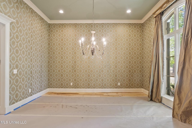 empty room with recessed lighting, wallpapered walls, ornamental molding, and an inviting chandelier